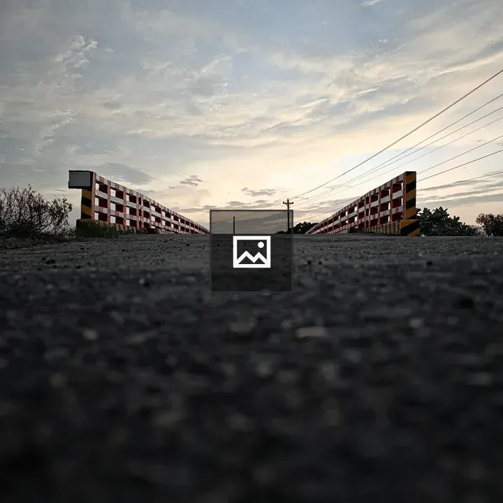 Asphalt road under small bridge
