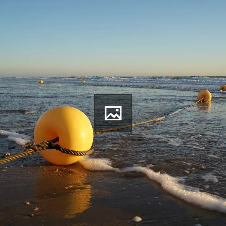 Yellow buoys on sandy beach