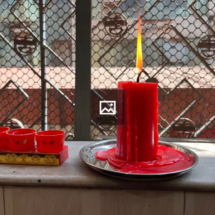 Red Candle on Silver Plate