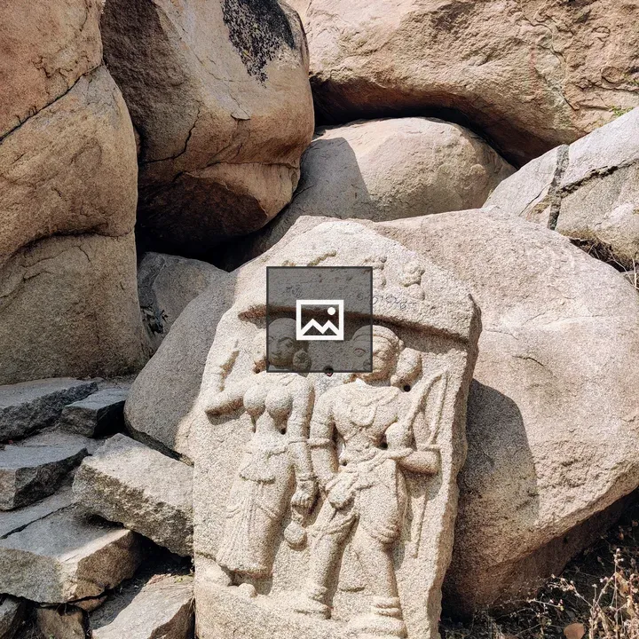 Ancient stone carving of two figures