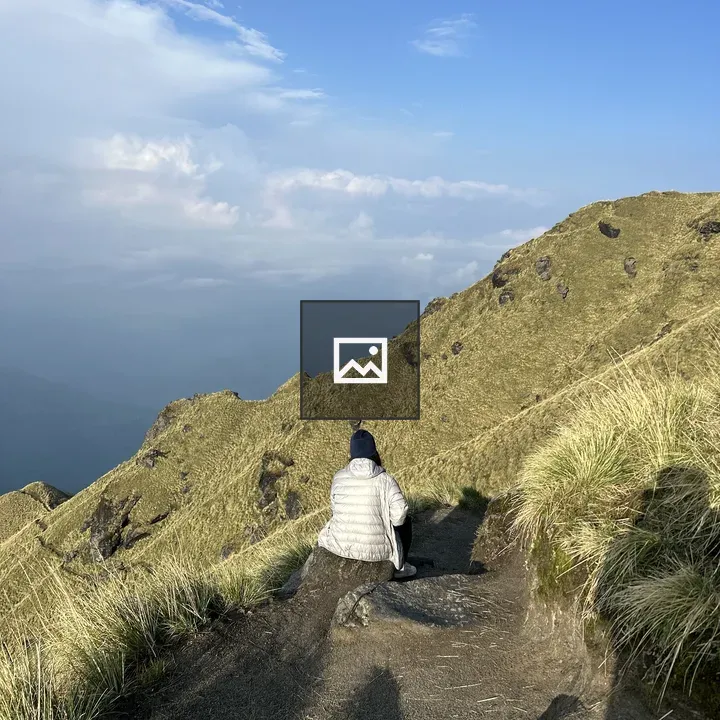 Trekker Sitting on Rocky Path