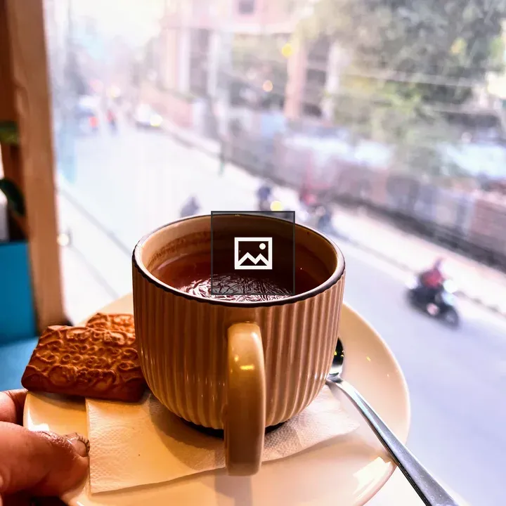 Hand holding mug of hot tea