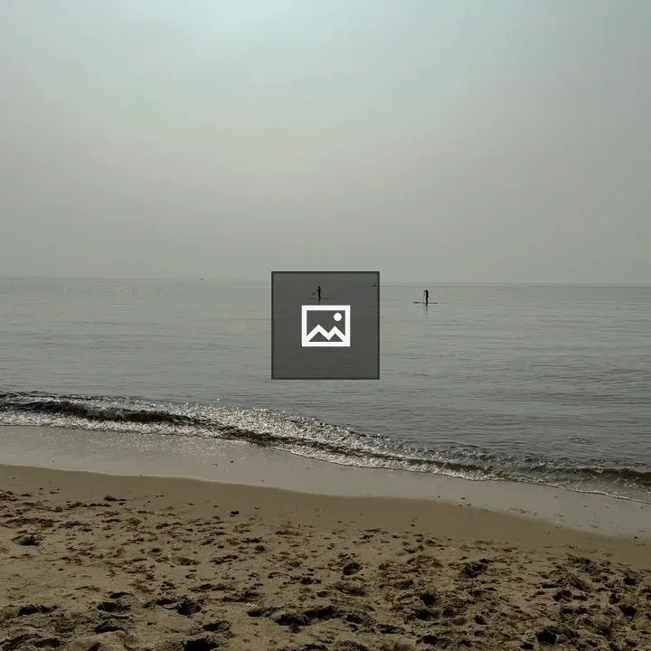 Paddle boarders at the hazy beach
