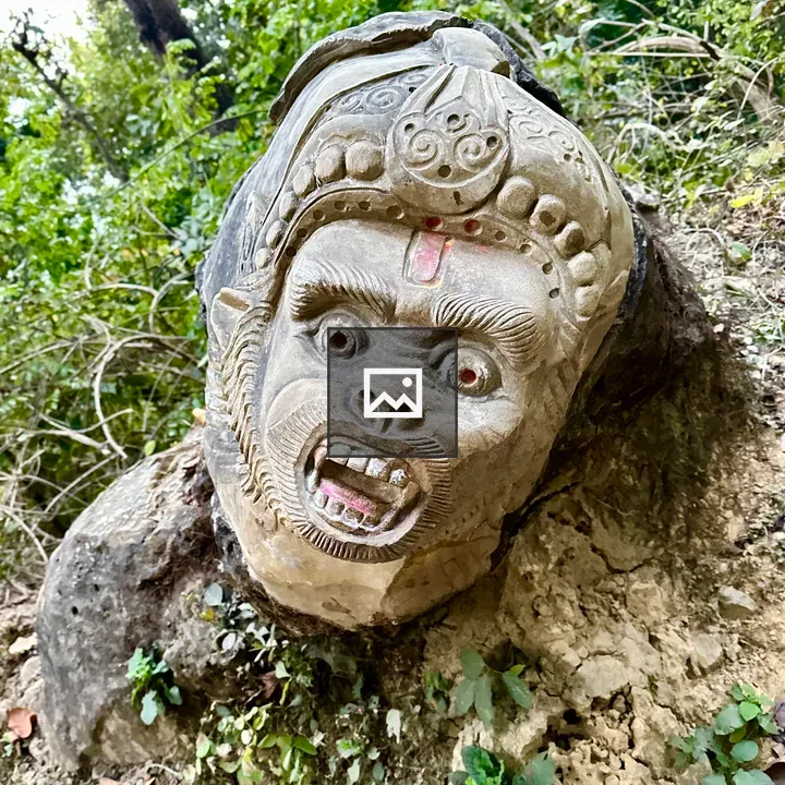 Stone sculpture of snarling face