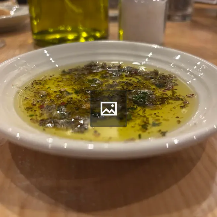 Olive oil with herbs on plate