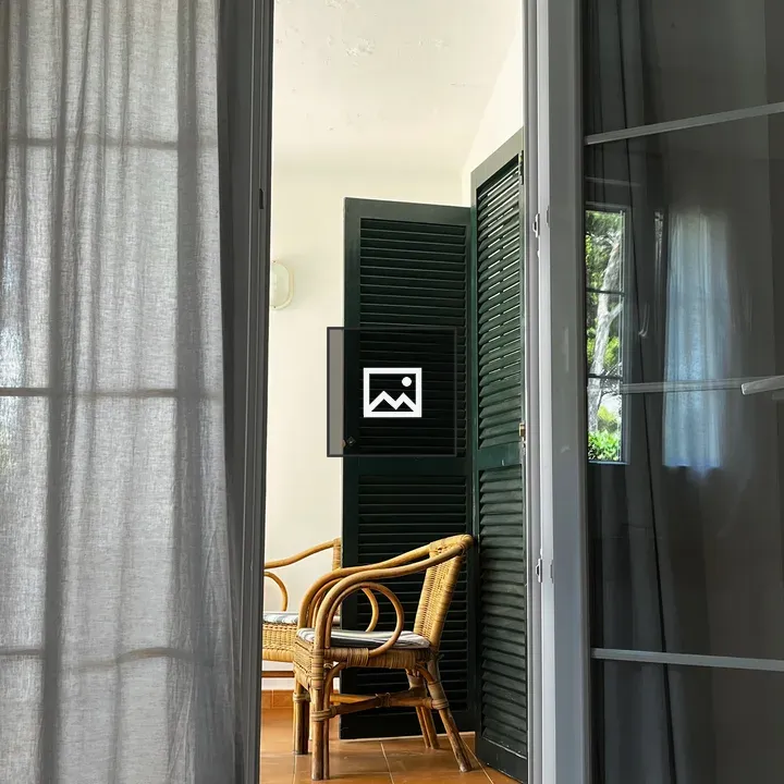 Terrace door view with wicker chairs