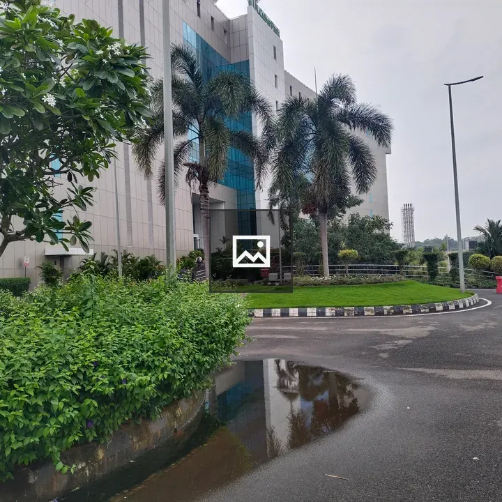 Modern glass building with greenery