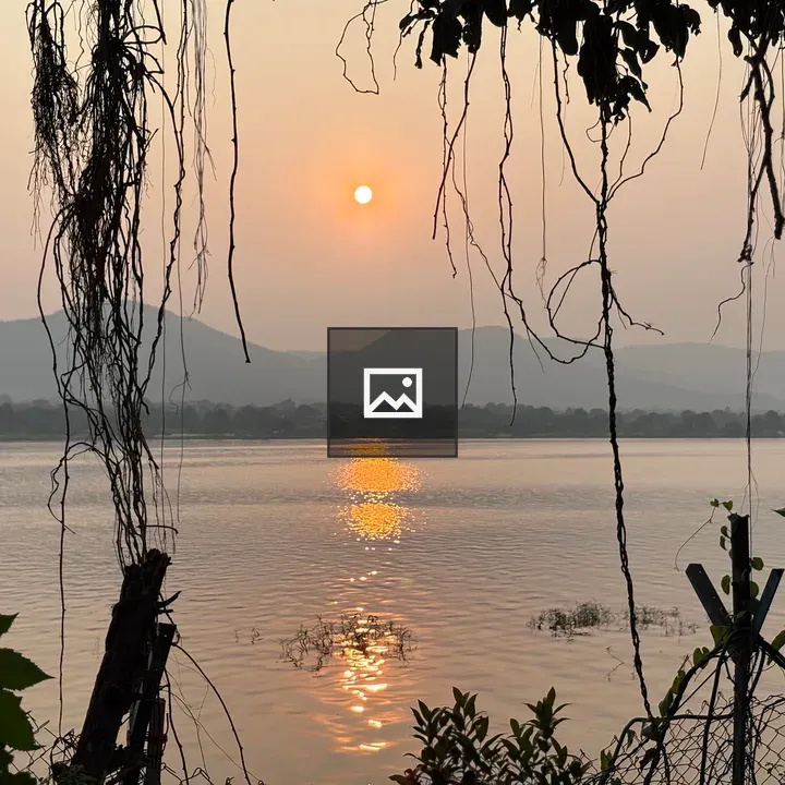Sunset over hazy sky river
