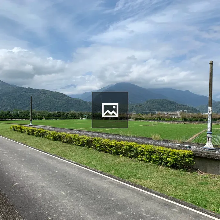 Unused railway station and green fields