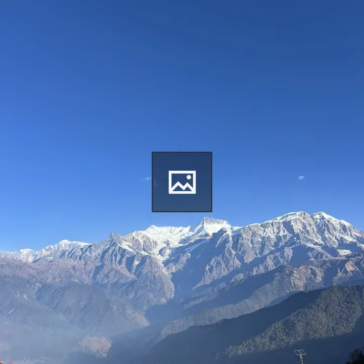 Snow-capped mountains under blue sky