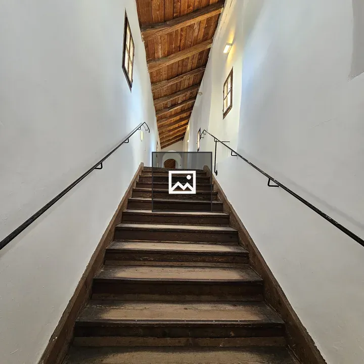 Wooden staircase with white walls