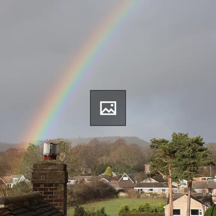 Rainbow Over Grey Sky with Houses