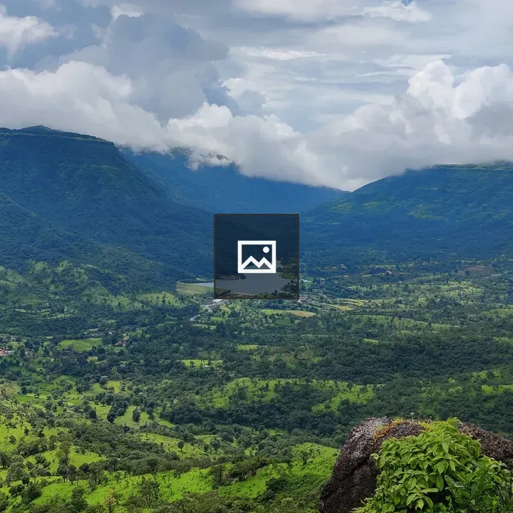 Valley Amid Mountains and Clouds
