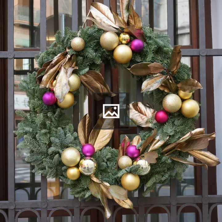 Christmas wreath hanging from a window