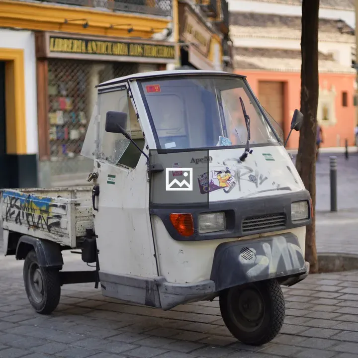 Three-wheeled delivery vehicle in urban setting