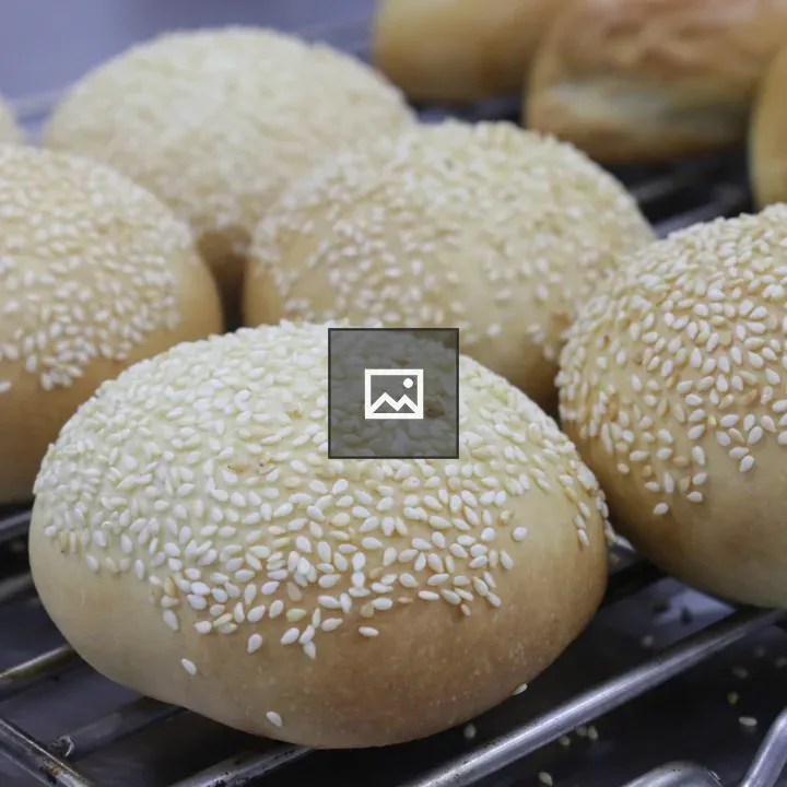 Sesame seed buns cooling on rack