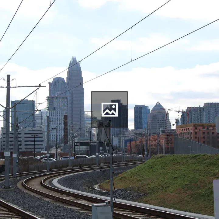 Charlotte Skyline Through Rail Lines