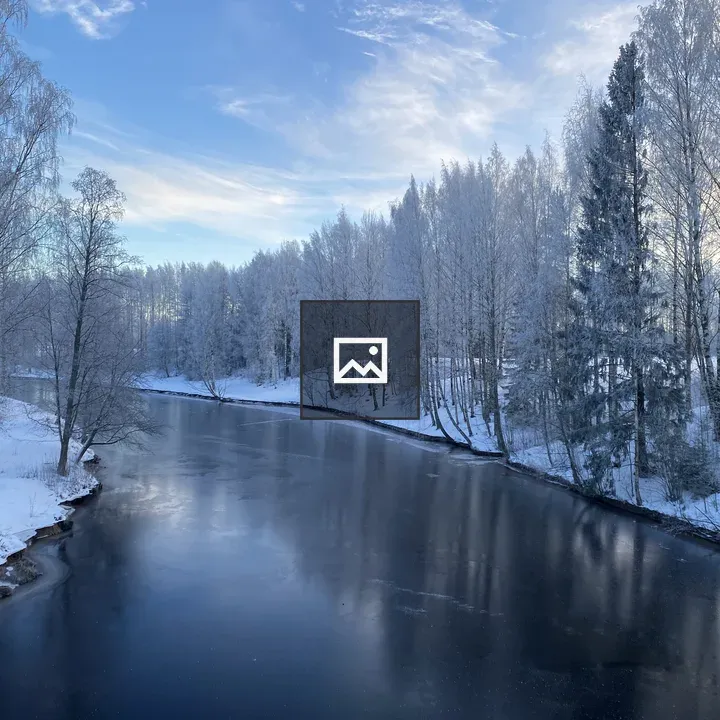 Winter landscape by frozen river