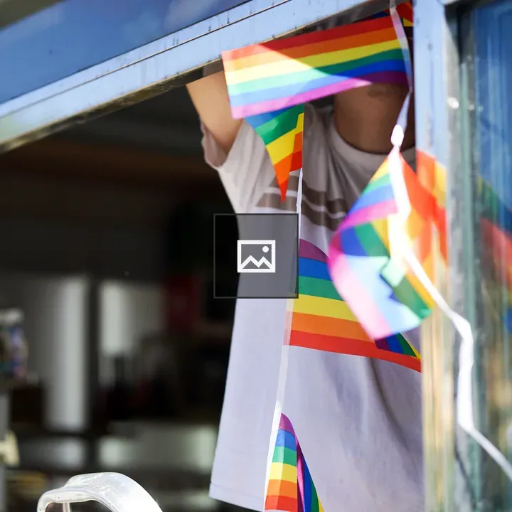 Shopkeeper Hanging Rainbow Flags