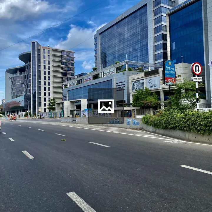 Wide road beside glass buildings