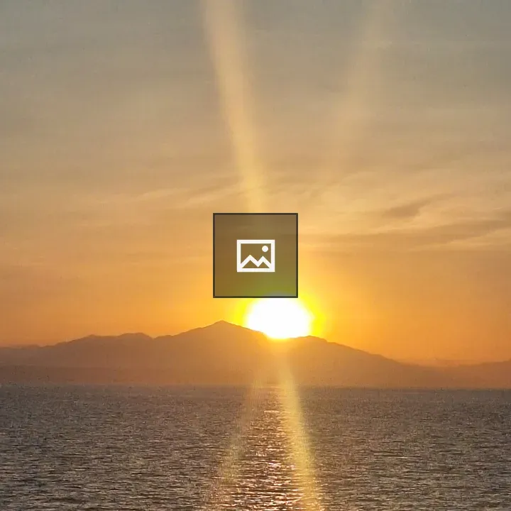 Sunset over Calm Water with Mountains