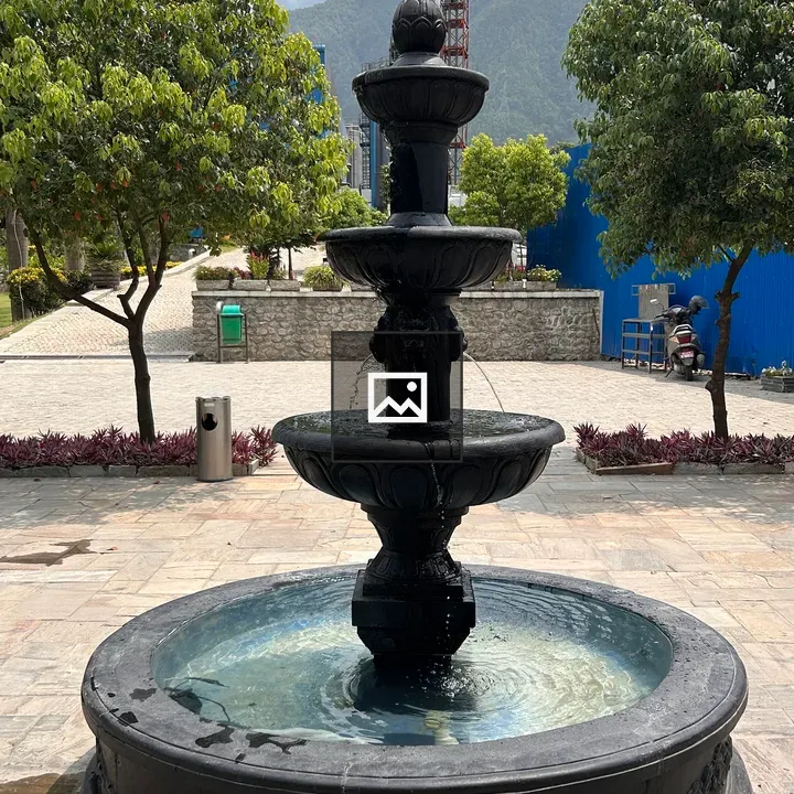 Black stone fountain with four tiers