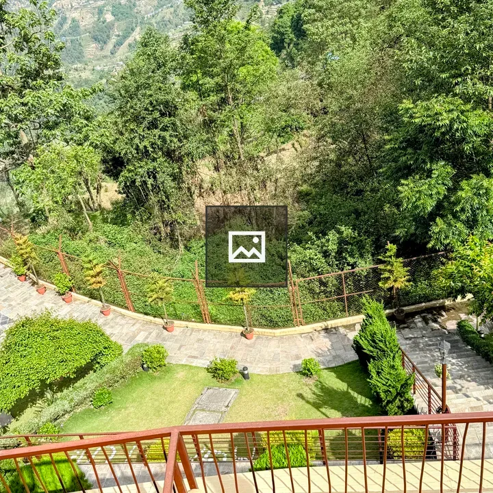 Balcony view of garden and hill