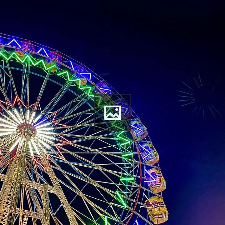 Illuminated ferris wheel at night