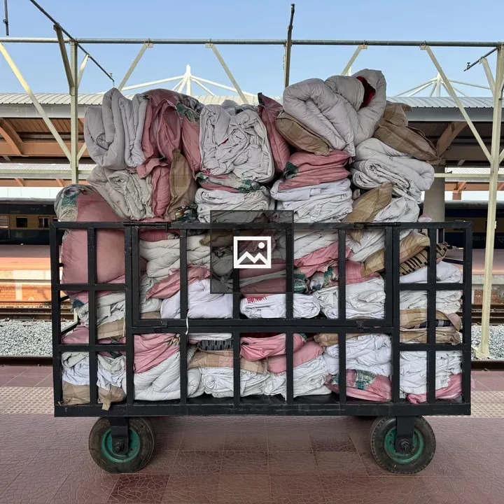 Metal cart on platform with folded linens