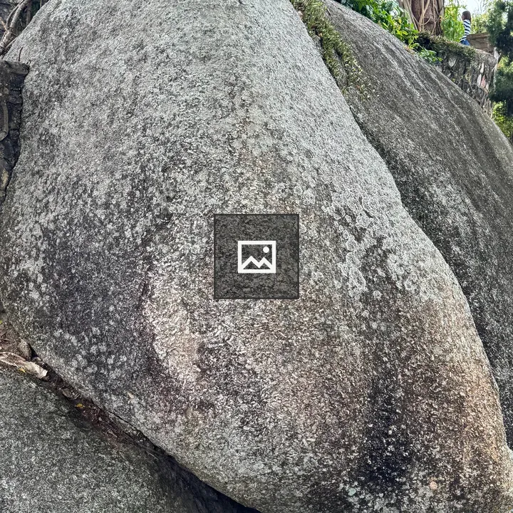 Weathered rock beside path