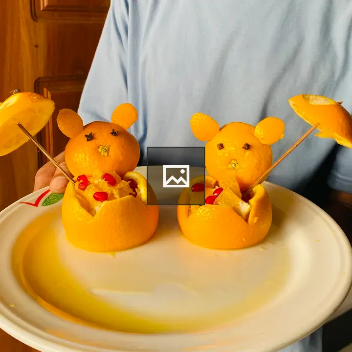 Person holding orange fruit bear plates