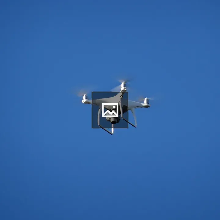 A white drone in blue sky