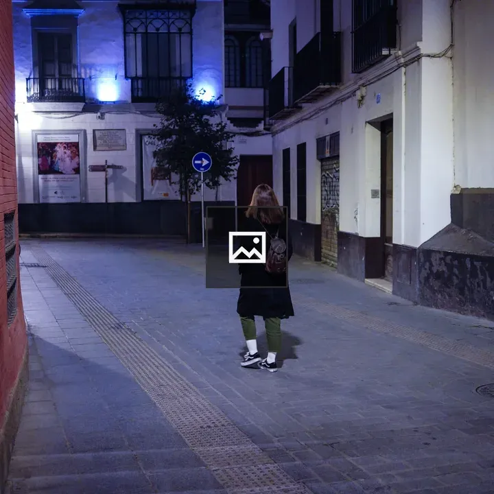 Night street with red wall and blue lights