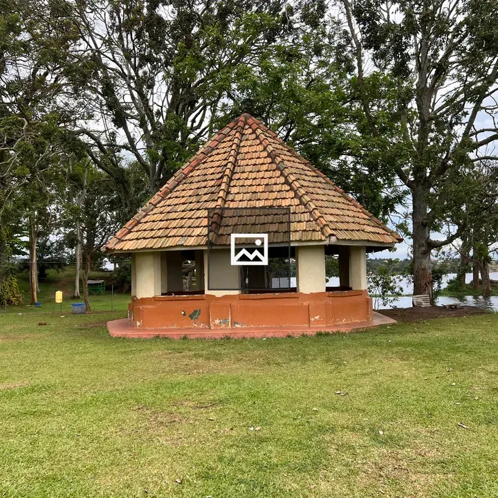 Polygonal building with trees and lake