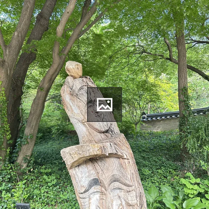 Wooden carving among foliage