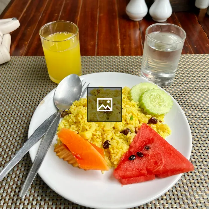 Yellow rice dish with fruit
