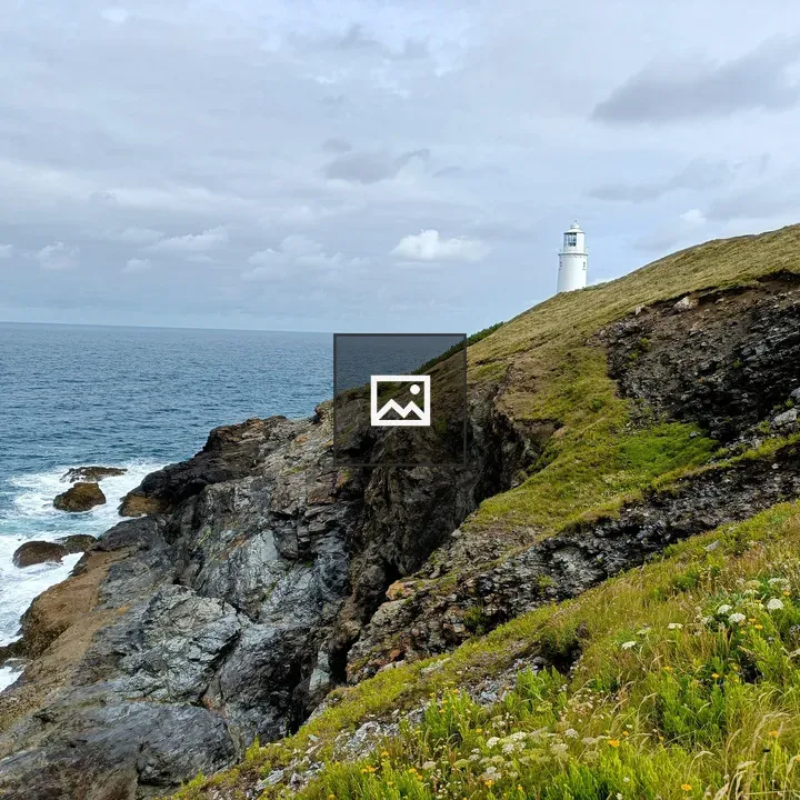 White lighthouse on grassy coast