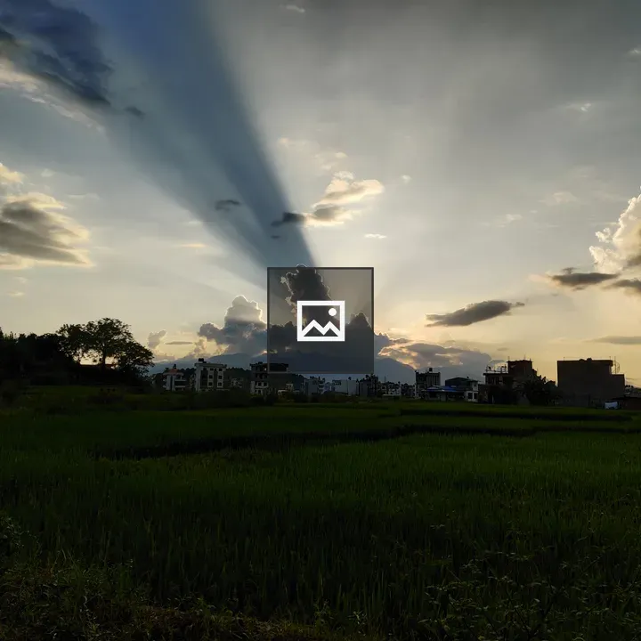 Clouds and sun rays over landscape