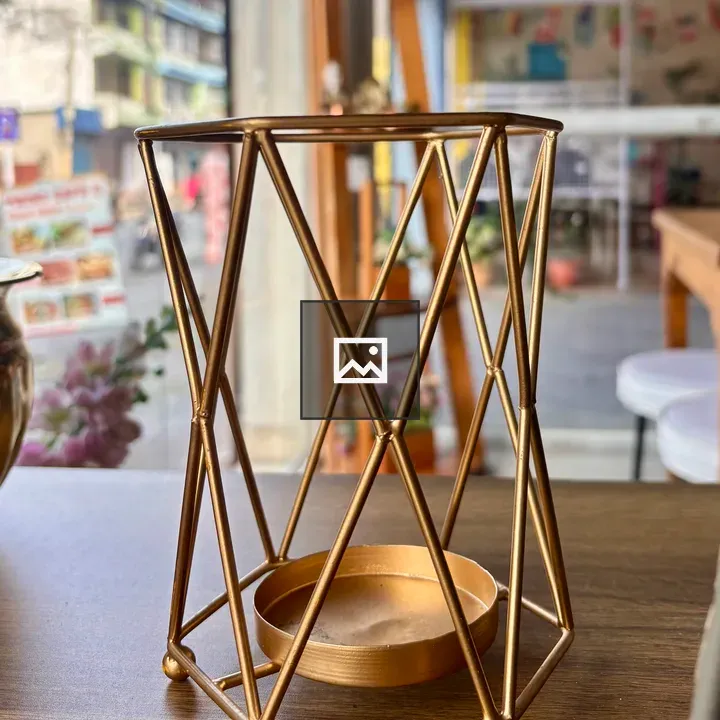 Golden candle holder on wood table