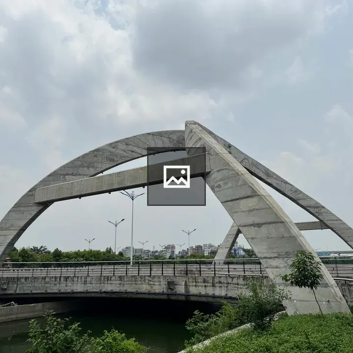 Concrete arch bridge under cloudy sky