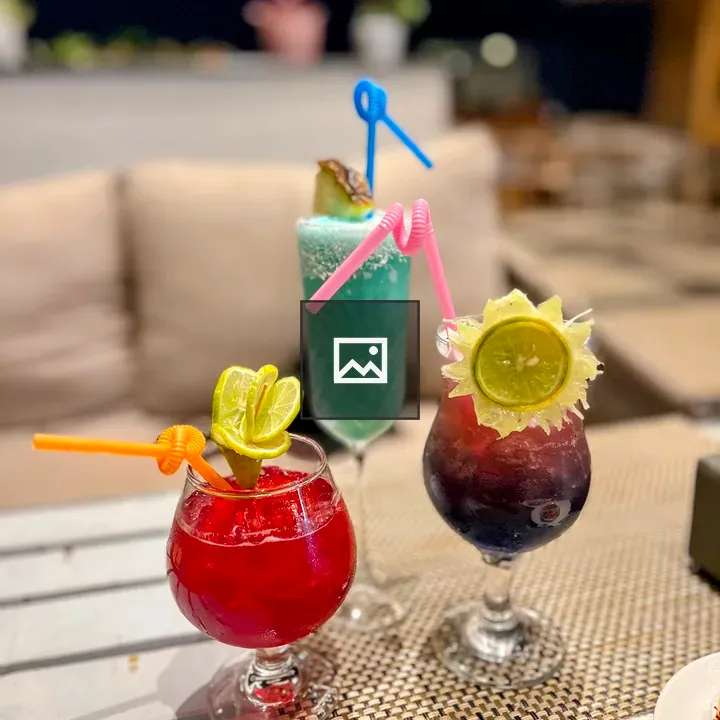 Three Tropical Cocktails at Night