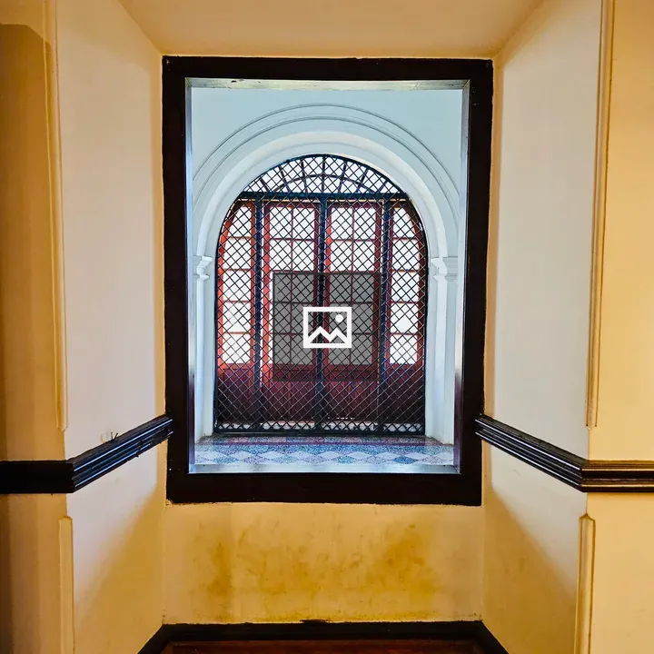 Arched wooden window in wall frame