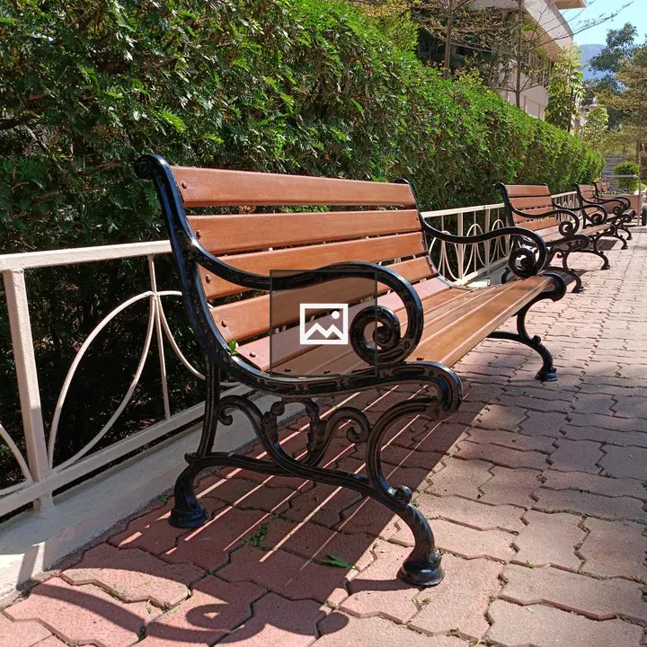 Empty benches along fence