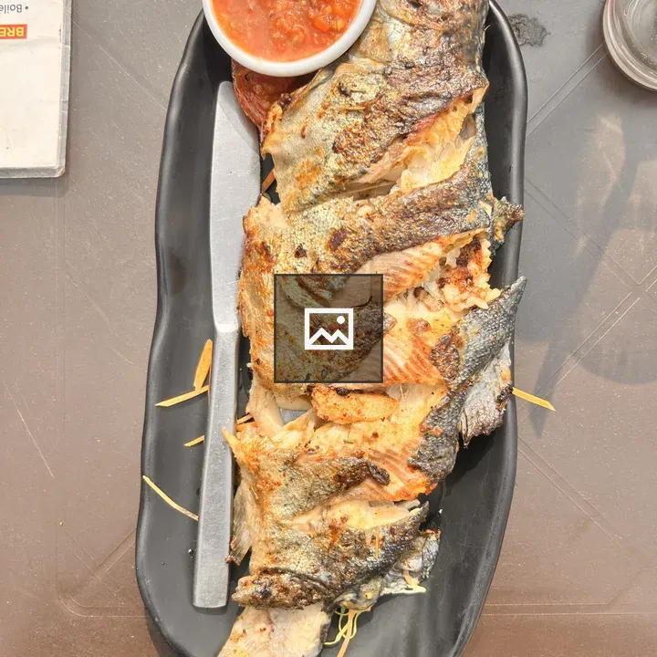 Grilled fish on black plate