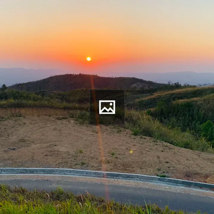 Sunset over rolling vegetation hills