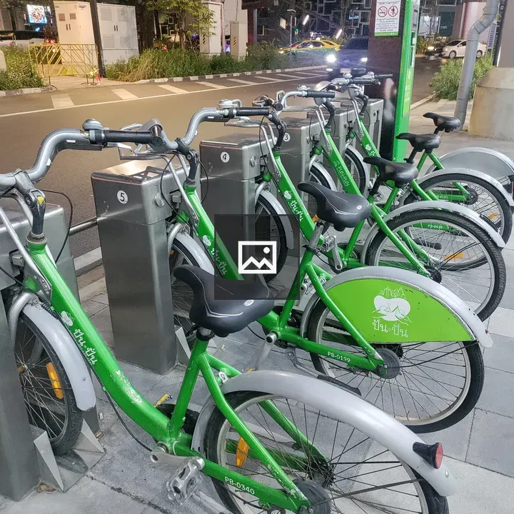 Row of green bicycles at night