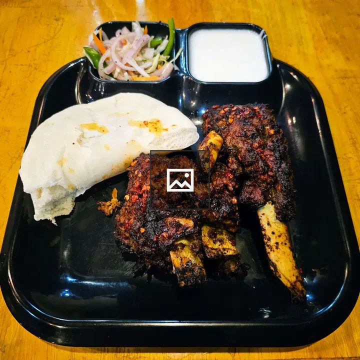 Spicy pork al faham on a plate