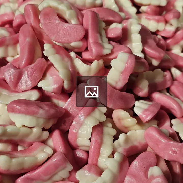 Pink and white gummy teeth close-up