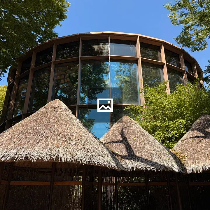 Modern circular building with thatched huts