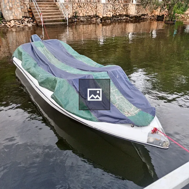 Small White Boat with Tarp